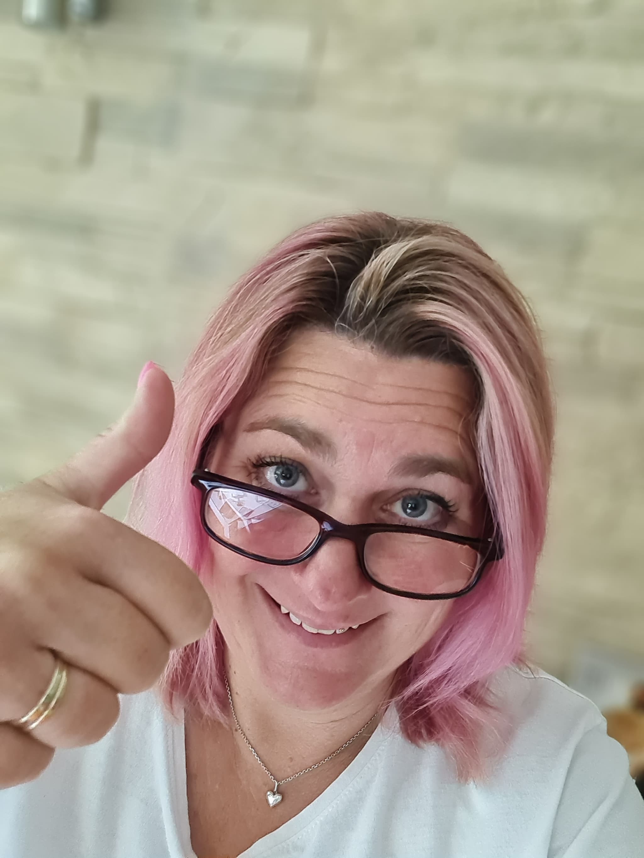 Nicky Welsh smiling behind her glasses